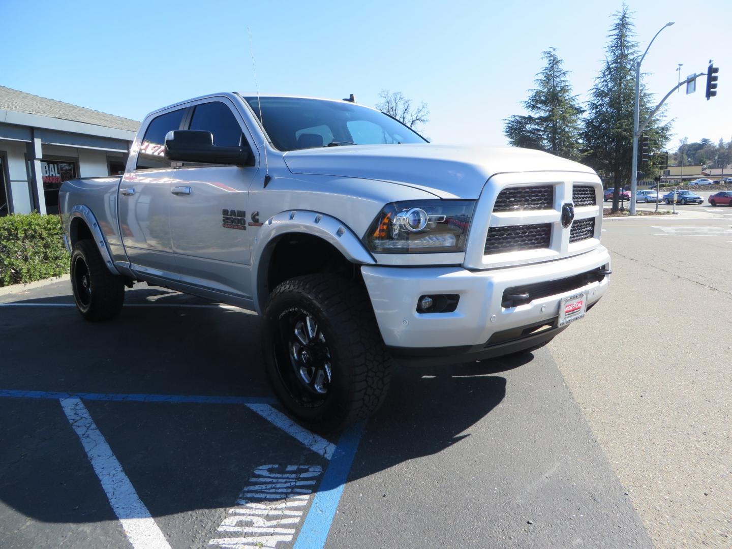 2016 SILVER /BLACK RAM 2500 Laramie Crew Cab SWB 4WD (3C6UR5FL3GG) with an 6.7L L6 OHV 24V TURBO DIESEL engine, 6A transmission, located at 2630 Grass Valley Highway, Auburn, CA, 95603, (530) 508-5100, 38.937893, -121.095482 - Leveled Ram sitting on Fuel Offroad wheels, Falken Wildpeak AT tires, Amp Power steps, Rolling Bed cover, Color matched fender flares, and window tint. - Photo#2